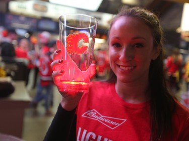 Laura Richards shows off the light up mugs given to Calgary Flames fans as they entered the Scotiabank Saddledome in Calgary on Monday April 17, 2017. The mugs were programmed to light up during the game opening and when the Flames score. Gavin Young/Postmedia Network