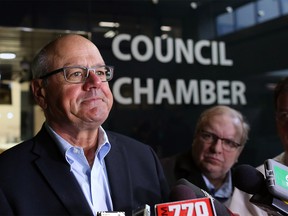 Calgary Flames President and CEO Ken King speaks with the media outside council chambers Monday.