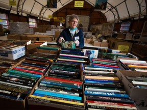 Volunteer Lyla Wall sorts books in preparation for the annual Servants Anonymous book sale at Crossroads Market on Thursday April 27, 2017. Gavin Young/Postmedia Network