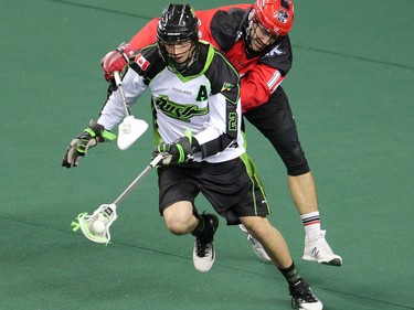 The Calgary Roughnecks' Wesley Berg chases down the Saskatchewan Rush's Brett Mydske during National Lacrosse League action in Calgary on Saturday April 29, 2017.