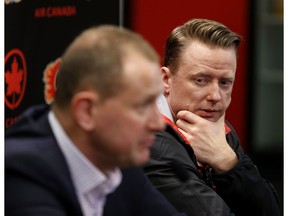 Calgary Flames general manager Brad Treliving, left and head coach Glen Gulutzan speak with the media at the Scotiabank Saddledome in Calgary on April 21, 2017. (Leah Hennel)