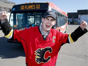 In this 2015 photo, Calgary Transit operator Steven Neilson mugs for a photo in a Calgary Flames jersey at the Calgary Transit's Spring Gardens. Transit is again relaxing its uniform policy on Flames' 2017 playoff run allowing operators to wear Flames clothing.