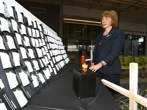 Charlotte Murray, the wife of fallen worker, poses following the Day of Mourning ceremonies at SAIT in Calgary on Friday to remember workers who were killed, injured or disabled on the job. Alberta lost 144 women and men to workplace injury or illness in 2016.