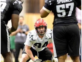 Connor McGough from the University of Calgary, centre, sizes up the opposition Asare Kwabena, left, and Qadr Spooner, right, before a drill at the 2017 CFL Combine at the Co-operators Centre in Regina Saturday, March 25, 2017.