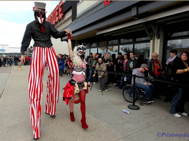 Circus performers enter the Marquee Beer Market as the crowd lines up during day two of the Insane Clown Posse Juggalo Weekend held at the Marquee Beer Market in Calgary, Alta on Saturday April 8, 2017. The two day festival, the first in Canada is headlined by ICP, and includes a number of other heavy metal, gangsta rap, DJs, wrestlers, and circus performers. Jim Wells/Postmedia