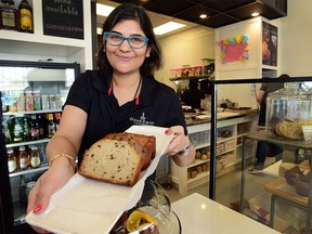 Ritu Agarwal, owner of Good Earth Coffeehouse Strathcona Square shows off one of their top selling baked goods, a chocolate chip banana bread in Calgary, Alta., on April 10, 2017. Reaction has been rolling in on social media and in the city of Calgary after a young child was forced to sit in a hall with his banana bread separate from other children, due to the snack being deemed "unhealthy." Ryan McLeod/Postmedia Network