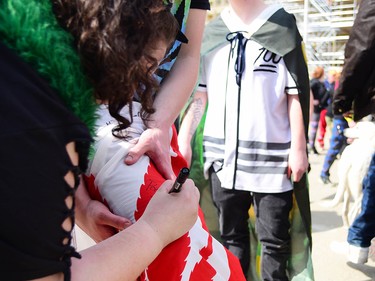 A Canadian cannabis plant flag is signed by those in attendance. 
Ryan McLeod/Postmedia Network