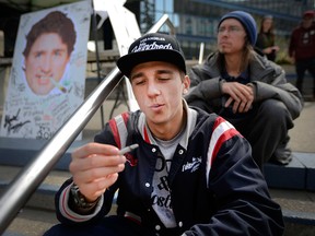 Chase McInnes smokes some weed on the steps of City Hall. Calgary pot advocates and users alike joined in the 4/20 (April 20) celebration of cannabis culture in Calgary on April 20, 2017 at City Hall. Ryan McLeod/Postmedia Network