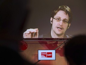 Edward Snowden, a former CIA worker before turning whistleblower, speaks via satellite at the IT fair CeBIT in Hanover, Germany, Tuesday March 21, 2017.