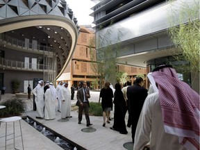 In this 2011 file photo, people visit the Masdar Institute campus, part of Masdar City, a Mubadala company, in Abu Dhabi, United Arab Emirates.