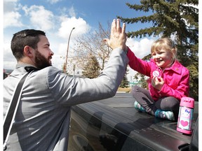 Calgary Flames player Deryk Engelland is greeted by young fan Faith Barber as the Flames were boarding the team bus in Calgary for the trip to Anaheim, Calif., on Tuesday April 11, 2017. Engelland wished the girl a happy fifth birthday and gave her a high five. The Flames play the Anaheim Ducks in the first round of the NHL Playoffs starting on Thursday. (Jim Wells)