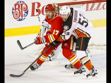 Lance Bouma of the Calgary Flames fights for position with Shea Theodore of the Anaheim Ducks during NHL action in Calgary, Alta., on Sunday, April 2, 2017. Lyle Aspinall/Postmedia Network