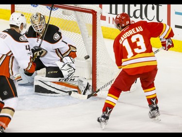 Johnny Gaudreau of the Calgary Flames comes close on Anaheim Ducks goalie Jonathan Bernier near Cam Fowler during NHL action in Calgary, Alta., on Sunday, April 2, 2017. Lyle Aspinall/Postmedia Network