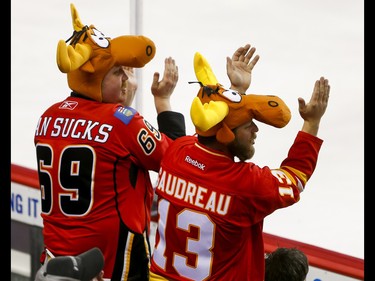 A pair of Calgary Flames fans wearing Bullwinkle hats, presumably in support of goalie Brian 'Moose' Elliott, cheer for a save during NHL action against the Anaheim Ducks in Calgary, Alta., on Sunday, April 2, 2017. Lyle Aspinall/Postmedia Network