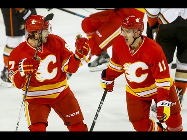 Michael Frolik and Mikael Backlund of the Calgary Flames celebrate a 3-3 game-tying goal on the Anaheim Ducks during NHL action in Calgary, Alta., on Sunday, April 2, 2017. The Ducks won 4-3. Lyle Aspinall/Postmedia Network