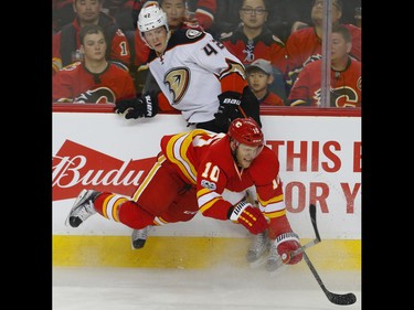 Calgary Flames Kris Versteeg collides with Josh Manson of the Anaheim Ducks during NHL hockey in Calgary, Alta., on Sunday, April 2, 2017. AL CHAREST/POSTMEDIA