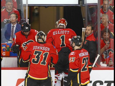 Flames goalie Brian Elliott (1) leaves the game and is replaced by Chad Johnson (31) after the Ducks first goal during NHL playoff game 4 action between the Calgary Flames and Anaheim Ducks in Calgary, Alta on Wednesday April 19, 2017. Jim Wells/Postmedia