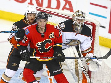 Ducks Brandon Montour (L) blocks out Flames Sean Monahan (C) in front of goalie Anaheim goalie John Gibson during NHL playoff game 4 action between the Calgary Flames and Anaheim Ducks in Calgary, Alta on Wednesday April 19, 2017. Jim Wells/Postmedia
