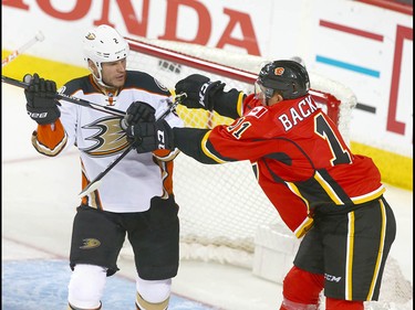 Ducks Kevin Bieksa (L) gets a cross check from Flames Mikael Backlund in front of the Ducks net during NHL playoff game 4 action between the Calgary Flames and Anaheim Ducks in Calgary, Alta on Wednesday April 19, 2017. Jim Wells/Postmedia