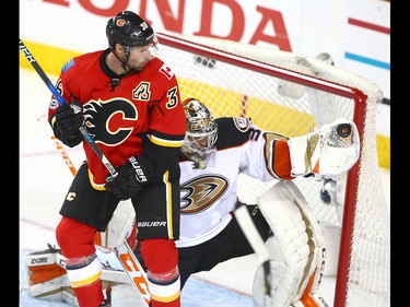 Ducks goalie John Gibson makes a glove save in front of Flames Troy Brouwer (L) during NHL playoff game 4 action between the Calgary Flames and Anaheim Ducks in Calgary, Alta on Wednesday April 19, 2017. Jim Wells/Postmedia