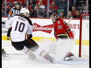 Calgary Flames goalie Chad Johnson stops a shot on net from Anaheim Ducks Corey Perry in NHL hockey action at the Scotiabank Saddledome in Calgary, Alta. on Wednesday April 19, 2017. Leah Hennel/Postmedia
