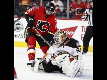Calgary Flames Mikael Backlund collides with Anaheim Ducks goalie John Gibson in NHL playoff hockey action at the Scotiabank Saddledome in Calgary, Alta. on Wednesday April 19, 2017. Leah Hennel/Postmedia