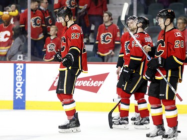 Calgary Flames Dougie Hamilton, left, and teammates react to their loss against the Anaheim Ducks in NHL playoff hockey action at the Scotiabank Saddledome in Calgary, Alta. on Wednesday April 19, 2017. Leah Hennel/Postmedia