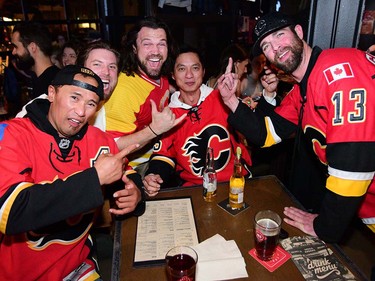 Left, Rodolfo Alcazar, Chris McCullough, Brad O'Donnell, Anthony Casten and Jason MacDonald cheer on the Calgary Flames. Calgary Flames fans were out in the bars on 17th Avenue in Calgary, Alta., on April 13, 2017. Flames are taking on the Anaheim Ducks in the first round of the NHL Playoffs. Ryan McLeod/Postmedia Network