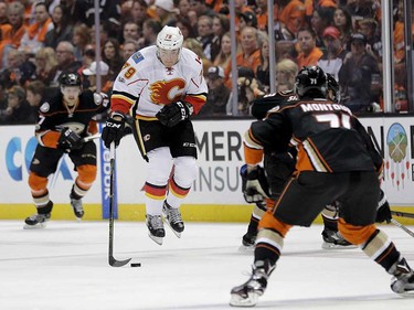 Calgary Flames' Michael Ferland, center, leaps as he moves the puck against the Anaheim Ducks during the first period in Game 1 of a first-round NHL hockey Stanley Cup playoff series Thursday, April 13, 2017, in Anaheim, Calif. (AP Photo/Jae C. Hong) ORG XMIT: CAJH103