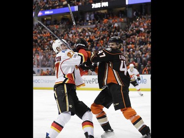 Anaheim Ducks' Hampus Lindholm, right, of Sweden, shoves Calgary Flames' Dougie Hamilton during the first period in Game 1 of a first-round NHL hockey Stanley Cup playoff series Thursday, April 13, 2017, in Anaheim, Calif. (AP Photo/Jae C. Hong) ORG XMIT: CAJH105