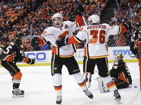 Calgary Flames' Sean Monahan, center left, celebrates his goal with Troy Brouwer during the first period in Game 1 of a first-round NHL hockey Stanley Cup playoff series against the Anaheim Ducks Thursday, April 13, 2017, in Anaheim, Calif. (AP Photo/Jae C. Hong)