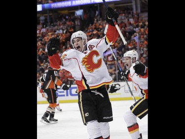 Calgary Flames' Sean Monahan, center, celebrates his goal against the Anaheim Ducks with Troy Brouwer during the first period in Game 1 of a first-round NHL hockey Stanley Cup playoff series Thursday, April 13, 2017, in Anaheim, Calif. (AP Photo/Jae C. Hong) ORG XMIT: CAJH111