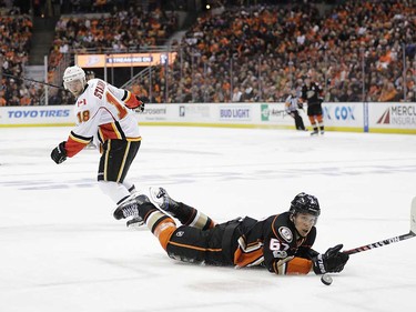 Anaheim Ducks' Rickard Rakell, front, of Sweden, falls to the ice as he moves the puck past Calgary Flames' Matt Stajan during the first period in Game 1 of a first-round NHL hockey Stanley Cup playoff series Thursday, April 13, 2017, in Anaheim, Calif. (AP Photo/Jae C. Hong) ORG XMIT: CAJH108