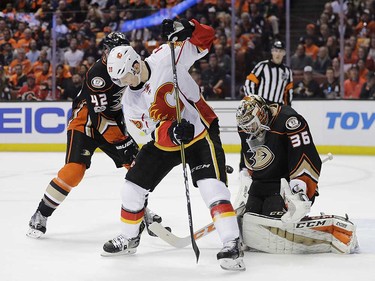 Anaheim Ducks goalie John Gibson, right, makes a save as Calgary Flames' Alex Chiasson stands in front of him during the first period in Game 1 of a first-round NHL hockey Stanley Cup playoff series Thursday, April 13, 2017, in Anaheim, Calif. (AP Photo/Jae C. Hong) ORG XMIT: CAJH107