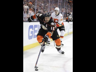 Anaheim Ducks' Ryan Getzlaf moves the puck as Calgary Flames' Matthew Tkachuk watches during the second period in Game 1 of a first-round NHL hockey Stanley Cup playoff series Thursday, April 13, 2017, in Anaheim, Calif. (AP Photo/Jae C. Hong) ORG XMIT: CAJH117