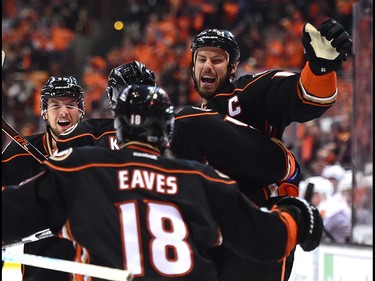 Ryan Getzlaf #15 of the Anaheim Ducks celebrates his goal with Shea Theodore #15 and Patrick Eaves #18 to take a 1-0 lead over the Calgary Flames during the first period in Game One of the Western Conference First Round during the 2017 NHL Stanley Cup Playoffs at Honda Center on April 13, 2017 in Anaheim, Calif.