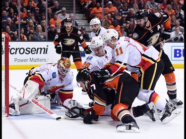 ANAHEIM, CA - APRIL 13:  Brian Elliott #1 of the Calgary Flames makes a save as Rickard Rakell #67 of the Anaheim Ducks looks for a rebound with and Mikael Backlund #11 and Michael Stone #26 during the first period in Game One of the Western Conference First Round during the 2017 NHL Stanley Cup Playoffs at Honda Center on April 13, 2017 in Anaheim, California.  (Photo by Harry How/Getty Images)