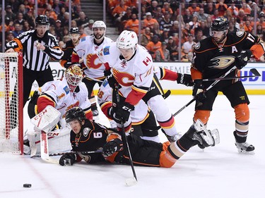 ANAHEIM, CA - APRIL 13:  Rickard Rakell #67 of the Anaheim Ducks looks for a rebound with Brian Elliott #1 and Mikael Backlund #11 of the Calgary Flames during the first period in Game One of the Western Conference First Round during the 2017 NHL Stanley Cup Playoffs at Honda Center on April 13, 2017 in Anaheim, California.  (Photo by Harry How/Getty Images)