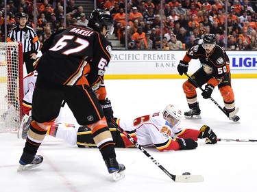 ANAHEIM, CA - APRIL 13:  Michael Stone #26 of the Calgary Flames attempts to block a pass from Rickard Rakell #67 to Antoine Vermette #50 of the Anaheim Ducks during the first period in Game One of the Western Conference First Round during the 2017 NHL Stanley Cup Playoffs at Honda Center on April 13, 2017 in Anaheim, California.  (Photo by Harry How/Getty Images)
