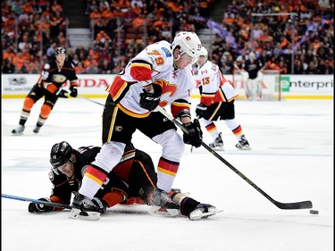 ANAHEIM, CA - APRIL 13:  Michael Ferland #79 of the Calgary Flames clears the puck from Corey Perry #10 of the Anaheim Ducks during a 3-2 Ducks win in Game One of the Western Conference First Round during the 2017 NHL Stanley Cup Playoffs at Honda Center on April 13, 2017 in Anaheim, California.  (Photo by Harry How/Getty Images)