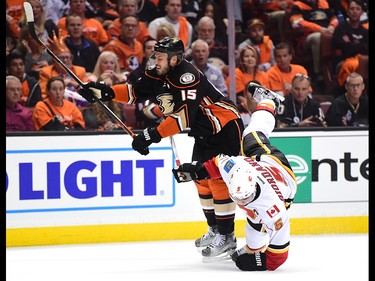 ANAHEIM, CA - APRIL 13:  Ryan Getzlaf #15 of the Anaheim Ducks checks Mark Giordano #5 to the ice during a 3-2 Ducks win in Game One of the Western Conference First Round during the 2017 NHL Stanley Cup Playoffs at Honda Center on April 13, 2017 in Anaheim, California.  (Photo by Harry How/Getty Images)