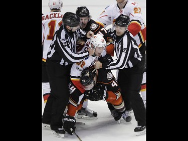 Anaheim Ducks' Nate Thompson, bottom, is grabbed by Calgary Flames' Troy Brouwer during the third period in Game 1 of a first-round NHL hockey Stanley Cup playoff series Thursday, April 13, 2017, in Anaheim, Calif. The Ducks won 3-2. (AP Photo/Jae C. Hong) ORG XMIT: CAJH119