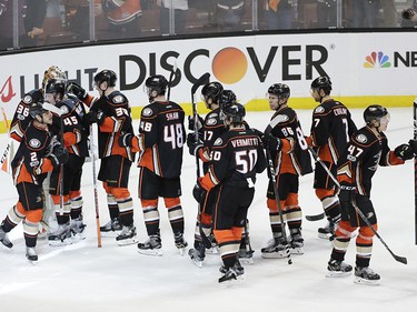 Anaheim Ducks players celebrate their team's 3-2 win against the Calgary Flames in Game 1 of a first-round NHL hockey Stanley Cup playoff series Thursday, April 13, 2017, in Anaheim, Calif. (AP Photo/Jae C. Hong) ORG XMIT: CAJH123