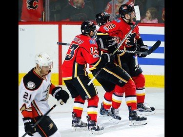 Calgary Flames Kris Versteeg celebrates with teammates Sean Monahan and Johnny Gaudreau after scoring against the Anaheim Ducks during the 2017 Stanley Cup playoffs in Calgary, Alta., on Monday, April 17, 2017. AL CHAREST/POSTMEDIA