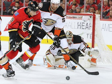 The Calgary Flames Alex Chiasson looks to grab the loose puck in front of the Anaheim Ducks Korbinian Holzer and goaltender John Gibson during game 3 of their Stanley Cup playoff series at the Scotiabank Saddledome on Monday April 17, 2017. Gavin Young/Postmedia Network