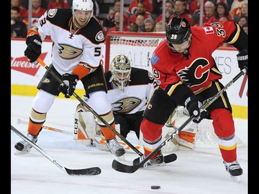 The Calgary Flames' Alex Chiasson looks to grab the loose puck in front of the Anaheim Ducks' Korbinian Holzer and goaltender John Gibson during game 3 of their Stanley Cup playoff series at the Scotiabank Saddledome on Monday April 17, 2017. Gavin Young/Postmedia Network
