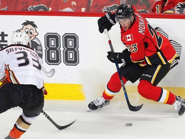 Calgary Flames  Sean Monahan skates the puck up the ice against Jakob Silfverberg of the Anaheim Ducks during the 2017 Stanley Cup playoffs in Calgary, Alta., on April 17, 2017.