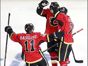 Calgary Flames Michael Stone, middle, celebrates his goal on the Anaheim Ducks with teammates Mikael Backlund, left and TJ Brodie, right, during NHL playoff action at the Scotiabank Saddledome in Calgary, Alta. on Monday April 17, 2017.