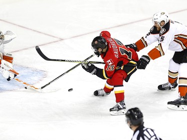 Calgary Flames Johnny Gaudreau, middle, tries to score on Anaheim Ducks goalie John Gibson as ducks Korbinian Holzer tries to stop him during NHL playoff action at the Scotiabank Saddledome in Calgary, Alta. on Monday April 17, 2017. Leah Hennel/Postmedia