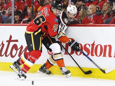 The Calgary Flames' Michael Stone and the Anaheim Ducks' Logan Shaw wrestle along the boards during game 3 of their Stanley Cup playoff series at the Scotiabank Saddledome on Monday April 17, 2017. Gavin Young/Postmedia Network